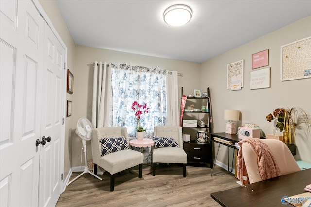 home office with light hardwood / wood-style flooring