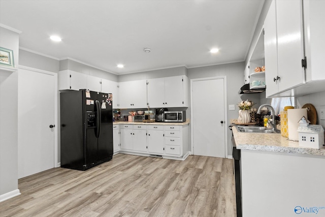 kitchen featuring sink, white cabinetry, black refrigerator with ice dispenser, and light wood-type flooring