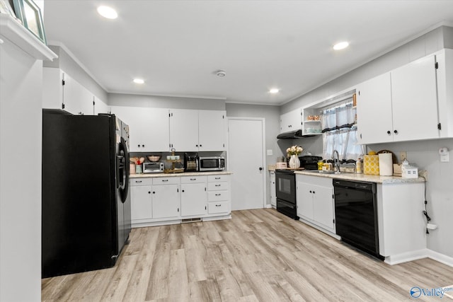 kitchen with white cabinetry, sink, black appliances, and light hardwood / wood-style flooring