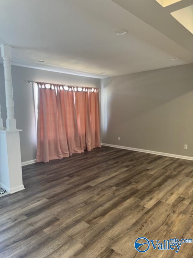 unfurnished room featuring dark hardwood / wood-style flooring