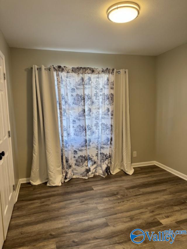 empty room with dark hardwood / wood-style floors