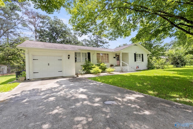 single story home featuring a front yard and a garage