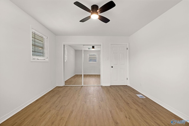 unfurnished bedroom with baseboards, light wood-style flooring, and visible vents