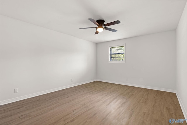 unfurnished room featuring baseboards, ceiling fan, and wood finished floors