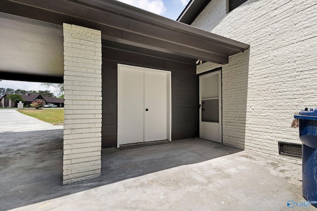 view of exterior entry featuring a patio area
