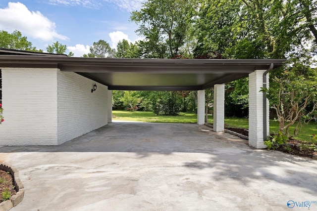view of parking featuring an attached carport and driveway