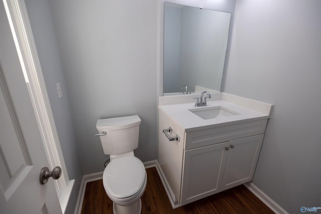 1204 Sibert Dr, Glencoe, AL 35905 - half bathroom featuring wood finished floors, vanity, toilet, and baseboards