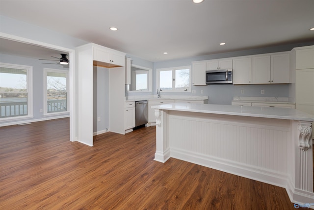 1204 Sibert Dr, Glencoe, AL 35905 - kitchen with stainless steel appliances, wood finished floors, light countertops, recessed lighting, and white cabinetry