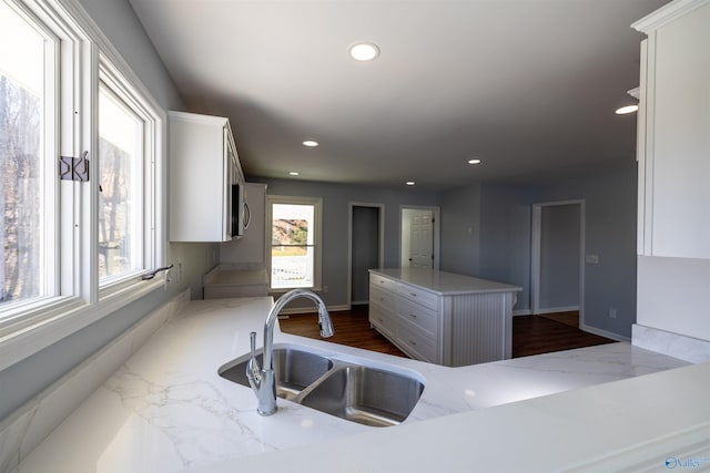 1204 Sibert Dr, Glencoe, AL 35905 - kitchen with a sink, white cabinets, dark wood-style flooring, recessed lighting, and a center island
