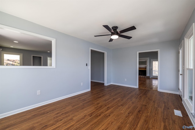 1204 Sibert Dr, Glencoe, AL 35905 - empty room with dark wood-style floors, a ceiling fan, baseboards, and a brick fireplace