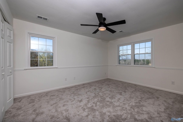 1204 Sibert Dr, Glencoe, AL 35905 - unfurnished bedroom featuring multiple windows, carpet floors, baseboards, and ceiling fan