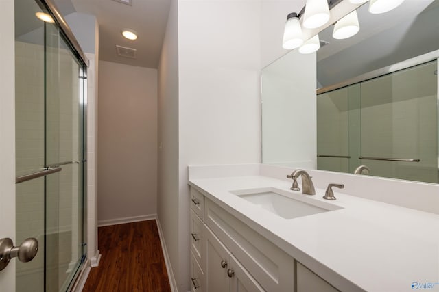 1204 Sibert Dr, Glencoe, AL 35905 - full bathroom featuring tiled shower, vanity, wood finished floors, baseboards, and recessed lighting