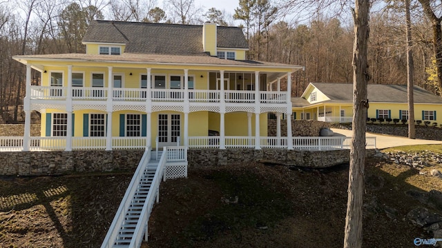 1204 Sibert Dr, Glencoe, AL 35905 - rear view of house featuring a balcony, covered porch, stairway, and a chimney