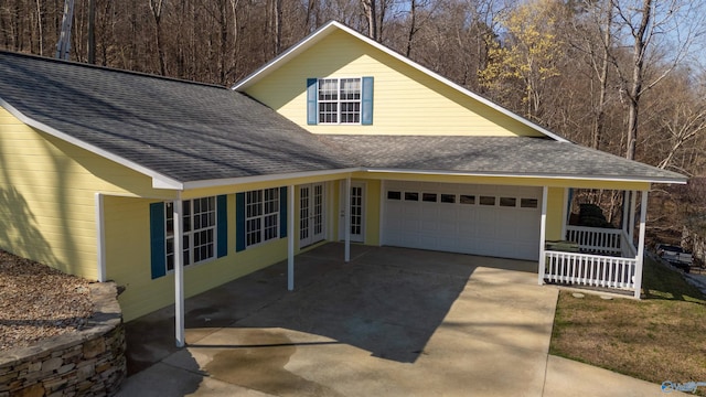 1204 Sibert Dr, Glencoe, AL 35905 - view of side of home with a shingled roof, an attached garage, and concrete driveway