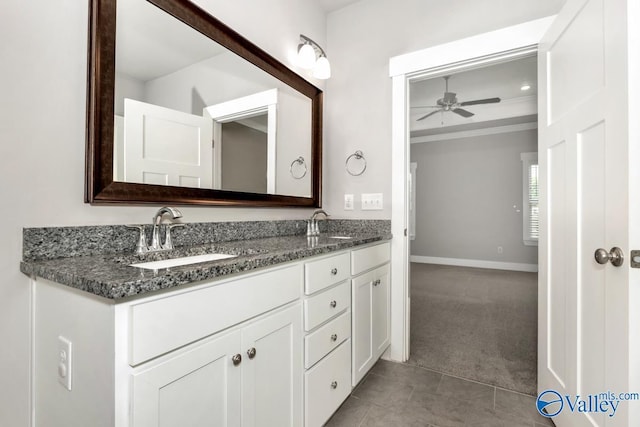 bathroom with tile patterned flooring, vanity, and ceiling fan