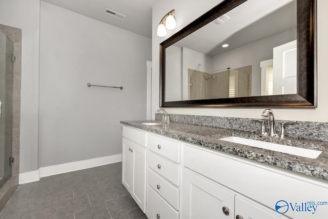 bathroom featuring tile patterned floors, vanity, and walk in shower