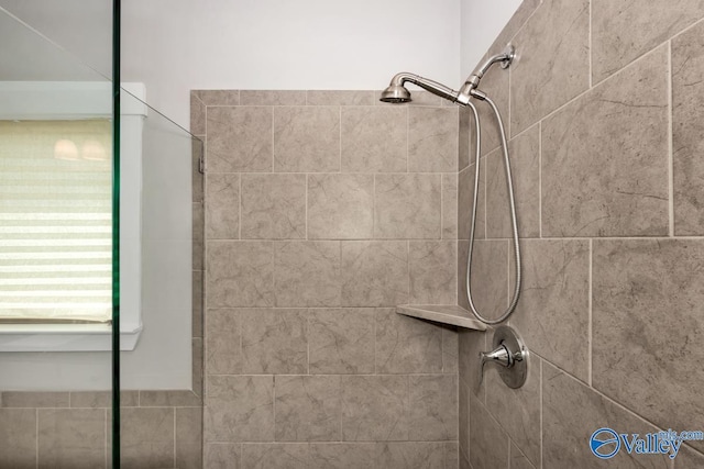 bathroom with a tile shower