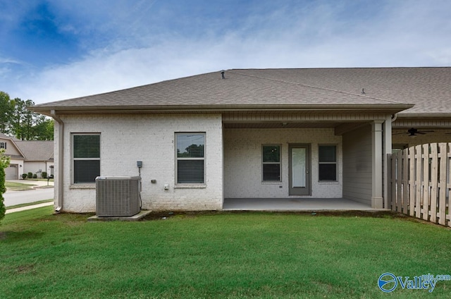 rear view of property with a yard, central AC, ceiling fan, and a patio area