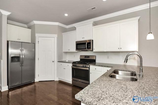 kitchen with hanging light fixtures, sink, appliances with stainless steel finishes, dark hardwood / wood-style flooring, and white cabinetry