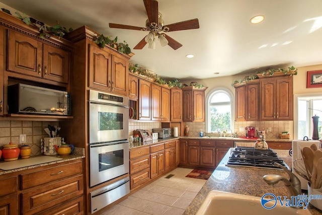 kitchen featuring decorative backsplash, appliances with stainless steel finishes, and a wealth of natural light