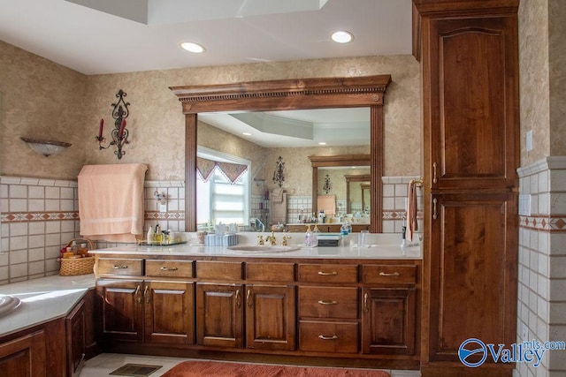 bathroom featuring vanity, tile walls, and tile patterned flooring