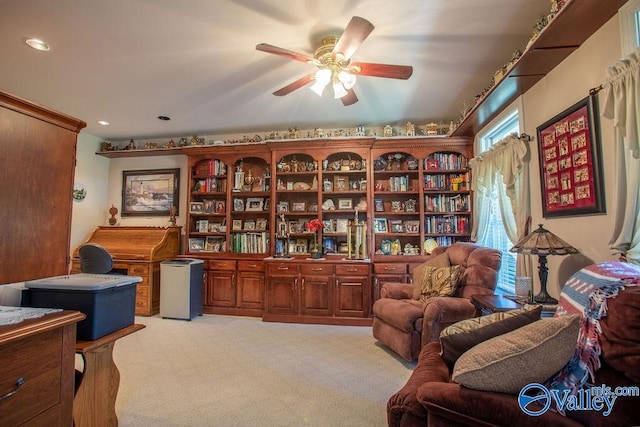 sitting room with light colored carpet and ceiling fan