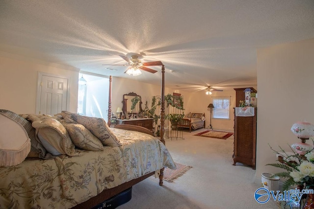 carpeted bedroom with a textured ceiling and ceiling fan