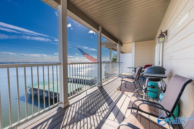 wooden terrace with a water view and a beach view