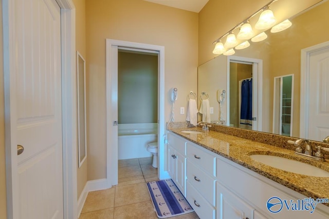 5590 Bay Hill Dr Unit 303, Athens, AL 35611 - full bathroom with double vanity, toilet, tile patterned flooring, and baseboards