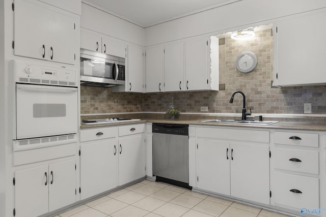 kitchen featuring white cabinetry, sink, backsplash, and stainless steel appliances