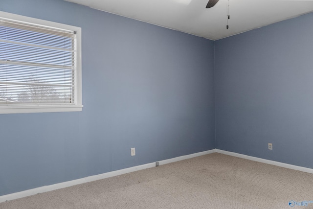 carpeted spare room with ceiling fan