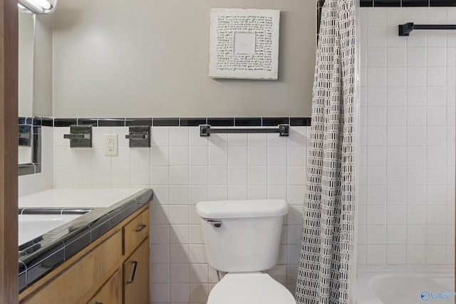 full bathroom with vanity, toilet, shower / tub combo, and tile walls