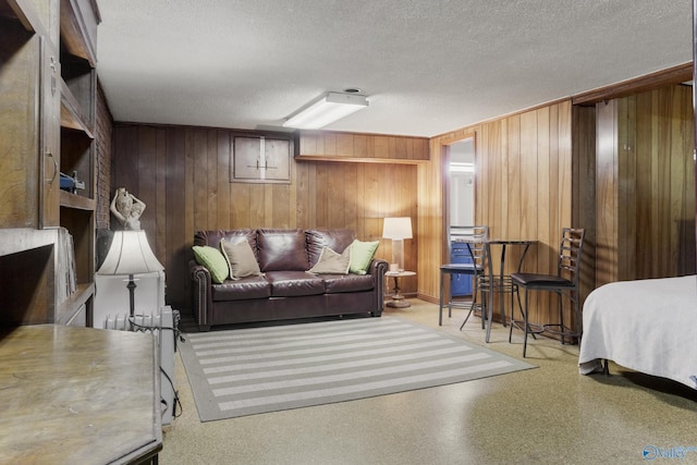 bedroom with wooden walls and a textured ceiling