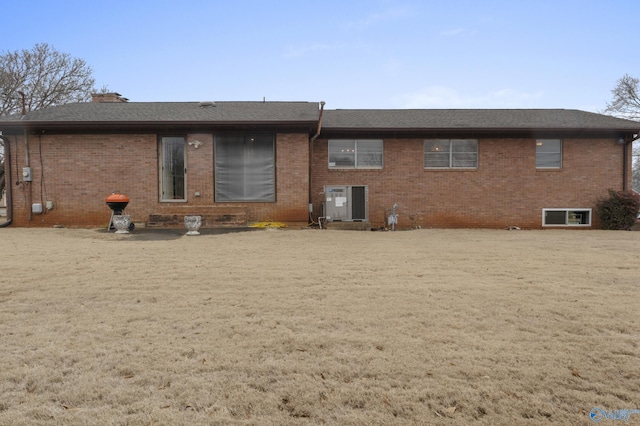 back of house featuring a yard and central AC unit