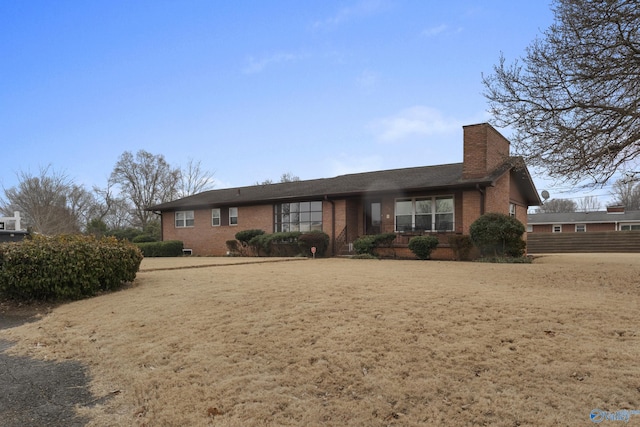 ranch-style home with a front lawn