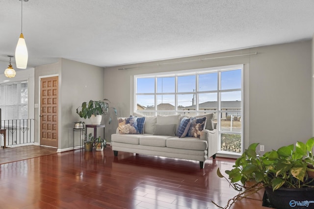 living room featuring dark hardwood / wood-style floors and a textured ceiling