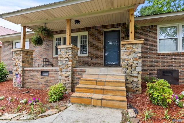 view of exterior entry with a porch