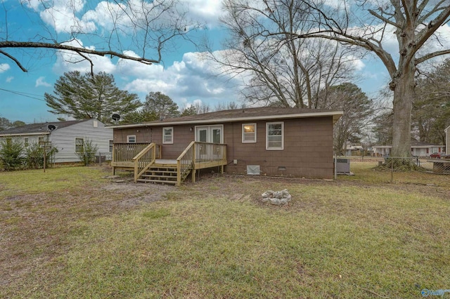 rear view of house with a lawn, a deck, and french doors