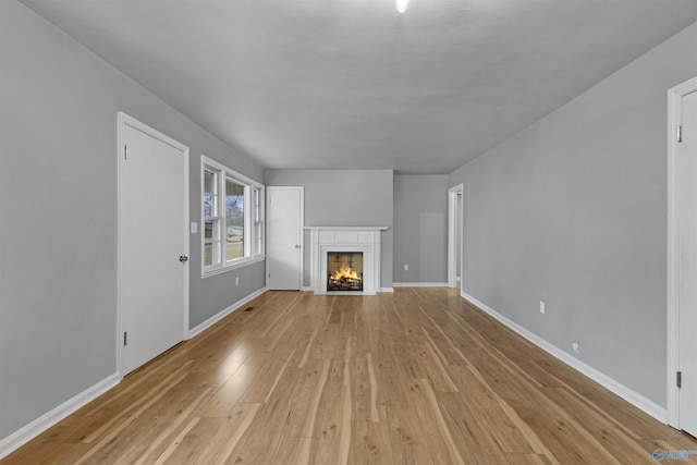 unfurnished living room with light hardwood / wood-style flooring