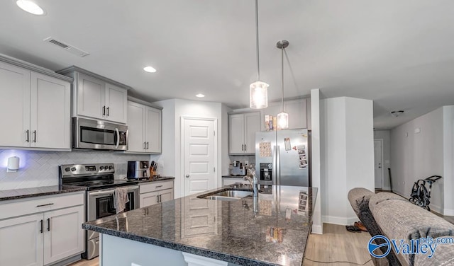 193 Cherry Laurel Dr, Hazel Green, AL 35750 - kitchen featuring appliances with stainless steel finishes, a sink, decorative backsplash, light wood-style floors, and gray cabinetry