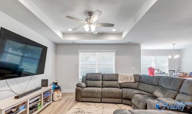 193 Cherry Laurel Dr, Hazel Green, AL 35750 - living room with a tray ceiling, a ceiling fan, a chandelier, light wood-style flooring, and recessed lighting