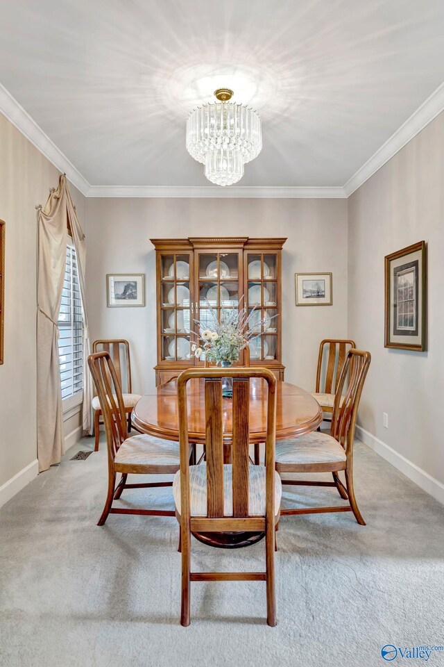 178 Ridgewood Cir, Cherokee Ridge, AL 35175 - dining room featuring a chandelier, light colored carpet, ornamental molding, and baseboards