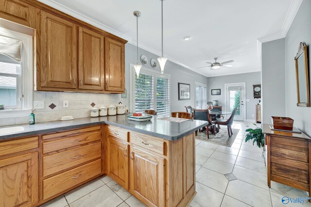 178 Ridgewood Cir, Cherokee Ridge, AL 35175 - kitchen featuring healthy amount of natural light, crown molding, a peninsula, dark countertops, and brown cabinetry