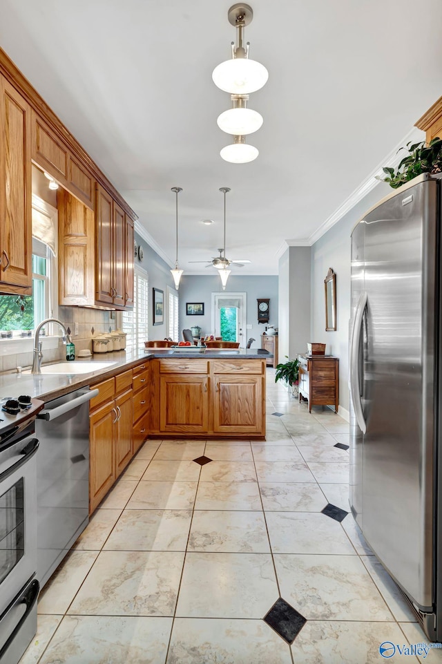 178 Ridgewood Cir, Cherokee Ridge, AL 35175 - kitchen with stainless steel appliances, plenty of natural light, ornamental molding, a peninsula, and decorative light fixtures