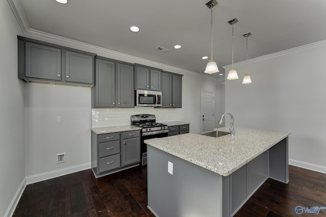 kitchen with decorative light fixtures, appliances with stainless steel finishes, light stone counters, and gray cabinets