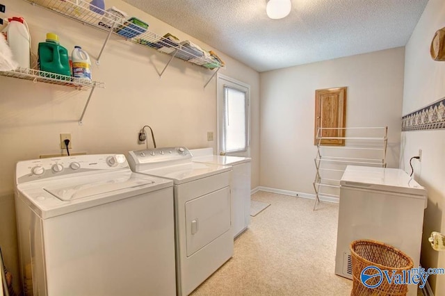 25000 Union Hill Rd, Ardmore, TN 38449 - laundry area with laundry area, baseboards, light colored carpet, a textured ceiling, and washing machine and clothes dryer