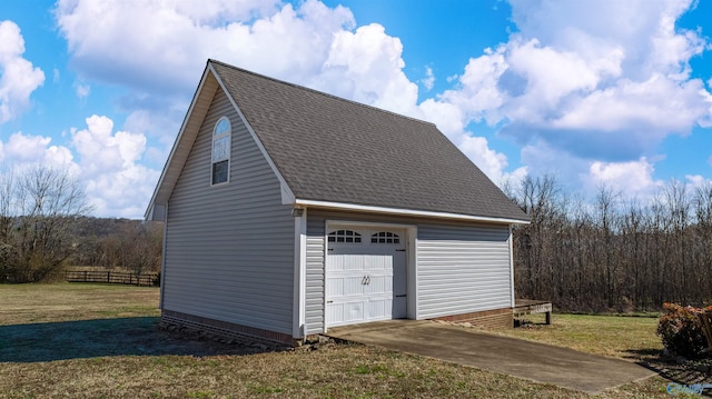 exterior space with driveway, fence, and an outdoor structure