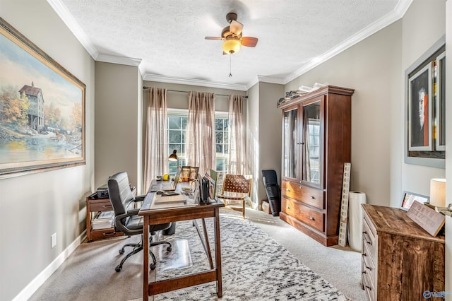 office area with ornamental molding, a ceiling fan, carpet flooring, a textured ceiling, and baseboards