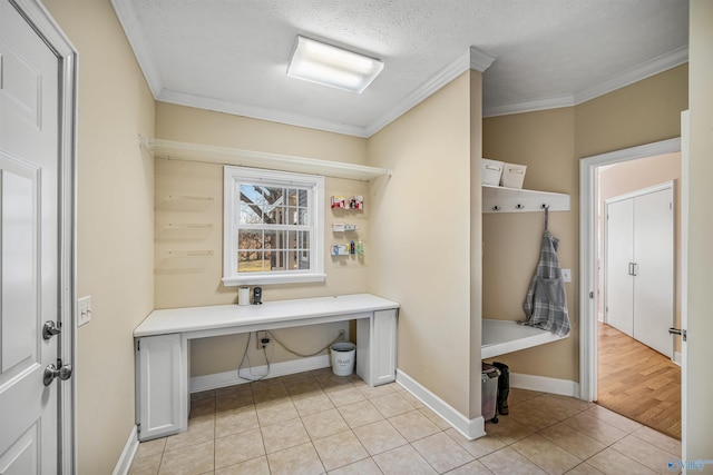 mudroom featuring ornamental molding, a textured ceiling, baseboards, and light tile patterned floors