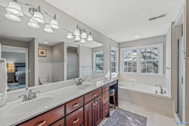 bathroom featuring toilet, a textured ceiling, visible vents, and a sink